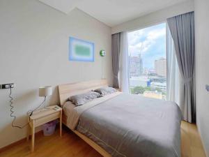 a bedroom with a bed and a large window at casa imobilier in Casablanca