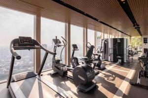 a gym with several cardio machines in a room with windows at casa imobilier in Casablanca