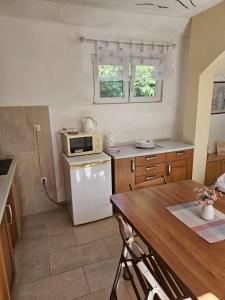 a kitchen with a white refrigerator and a microwave at Apartment Dalma in Podgora