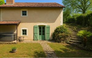 een huis met een groene deur en een trap die ernaartoe leidt bij Echappée verte et jacuzzi proche de Paris in Vert-le-Grand +6 foto's