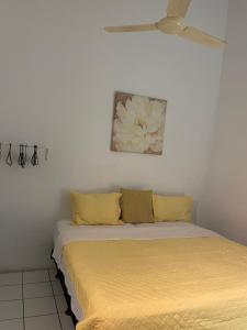 a bedroom with two beds with yellow pillows at Tropical Harbour View in Monchy