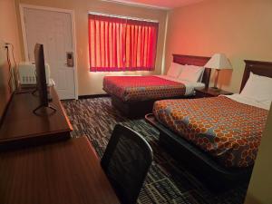a hotel room with two beds and a table at Ashford Motel in Ashford