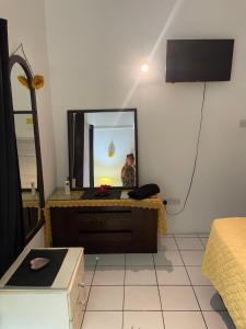 a living room with a mirror and a tv at Tropical Harbour View in Monchy