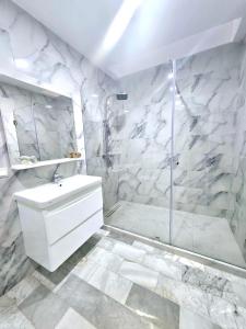 Oulad AkkouにあるVilla Luxury Suissi Rabatのシャワーと洗面台を備えた白いバスルーム +27枚の写真