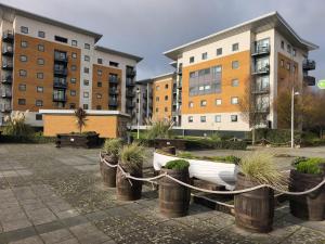 a row of boats in a courtyard with buildings at Modern 4-bed home Royal Wharf near Excel Canary Wharf London city airport The O2 -Free parking in North Woolwich