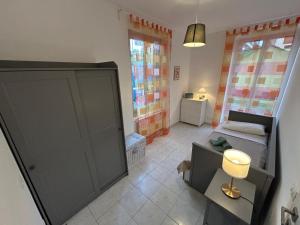 a small room with a bed and a cabinet at Il nido di Fra&Gab in Genova
