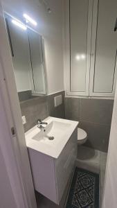 a bathroom with a white sink and a toilet at Il nido di Fra&Gab in Genova