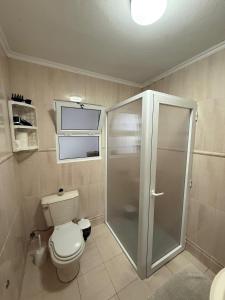 a bathroom with a toilet and a glass shower at Casa da Boa Ventura in Vila Franca do Campo +5 photos