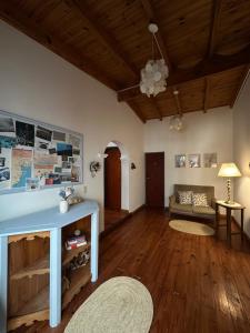 a living room with a blue table and a couch at Hostería Isabel in Las Grutas