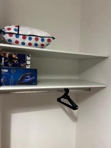 a white shelf with a suitcase on it at Spacious apartment in Tétouan
