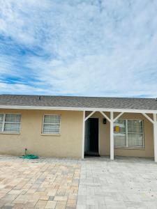 a yellow house with a driveway in front of it at Discovery Cove Sarasota in Sarasota