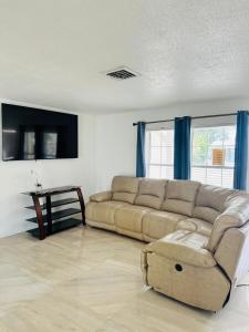 a living room with a couch and a table at Discovery Cove Sarasota in Sarasota