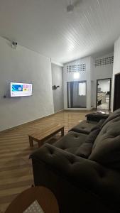 a living room with a couch and a tv at Casa no Centro de Prado in Prado