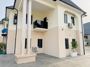 a white house with a tv on the side at StayatMargarets in Abuja