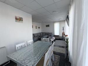 a living room with a table and a couch at Mountain Relax Vlašić in Vlasic