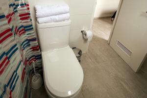 een badkamer met een wit toilet in een kamer bij Incredible apartment, front beach la horseshoe  +24 foto's