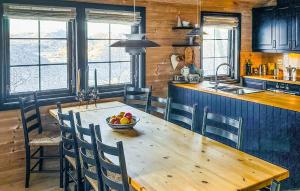 a kitchen with a wooden table with a bowl of fruit on it at Awesome Home In Tjørhom in Haugen