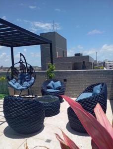a group of chairs sitting on top of a roof at Flat Beach Way caminho da praia in Cabedelo