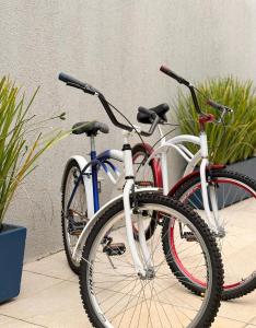 two bikes are parked next to each other at Pousada Três Marias - Guaiuba in Guarujá