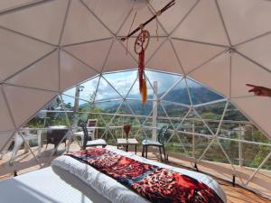 a room with a large glass dome with a bed in it at Glamping Guacharaca Silvanía Cundinamarca in Silvania