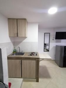 a kitchen with a sink and a counter top at Tu Loft Ideal Amoblado, Wifi, Parqueadero y Confort in Bucaramanga
