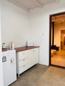 a kitchen with a counter and a refrigerator at Casa Raices in Quequén