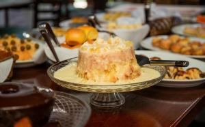a piece of cake on a plate on a table at Pousada Três Marias - Guaiuba in Guarujá