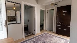 a hallway with a door leading to a bathroom at Yade Apart Pension in Ayvalık +26 photos