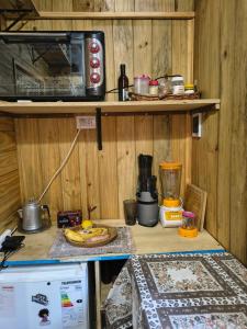 a kitchen with a counter top with a table with a pizza at Refugio CASA NAVE Torre del Bosque in San Eduardo del Mar