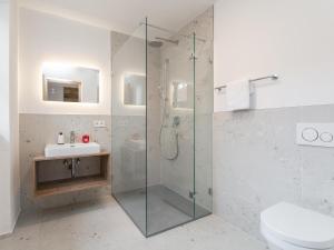 a bathroom with a glass shower and a sink at Hopfgarten Alpin Living Top 3 in Hopfgarten im Brixental +32 photos