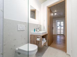 a bathroom with a toilet and a sink at Hopfgarten Alpin Living Top 6 in Hopfgarten im Brixental +23 photos
