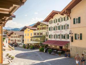 a group of buildings in a town with people walking at Hopfgarten Alpin Living Top 1 und 2 in Hopfgarten im Brixental