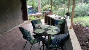 a patio with a table and chairs on a patio at Ecotropicfarmhouse in Cerro Azul