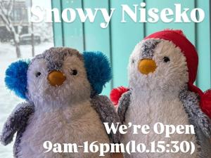 two stuffed birds sitting next to each other in the snow at Tbox in Kutchan
