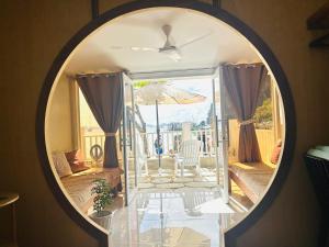 a mirror in a living room with a table and an umbrella at El Nido, Corong Corong Pier in El Nido