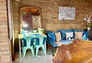 a patio with a table and chairs and a couch at One Cabañas 2 in Los Antiguos