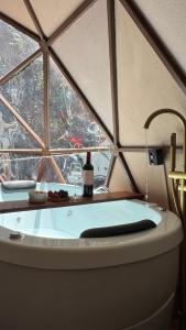 a bath tub in a room with a window at Cabana winchesters - Domo in Cascavel