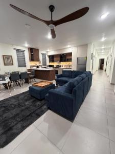 a living room with two blue couches and a ceiling fan at Excellent 2-Bedroom Condo in Gated Community in Philipsburg