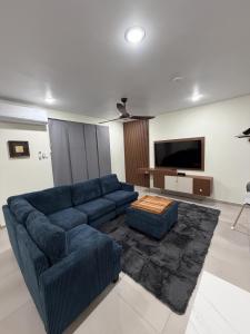 a living room with a blue couch and a flat screen tv at Excellent 2-Bedroom Condo in Gated Community in Philipsburg +39 photos