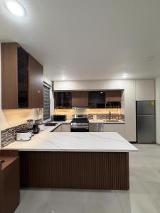 a large kitchen with a large white counter top at Excellent 2-Bedroom Condo in Gated Community in Philipsburg