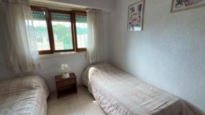 En eller flere senge i et værelse på Edificio Natania