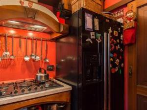 a kitchen with a black refrigerator and a stove at Romantic & Artistic Apartment in Milan