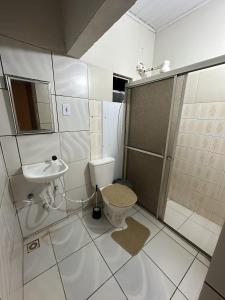 een badkamer met een toilet, een wastafel en een douche bij Zig Zag Hostel in Itacaré