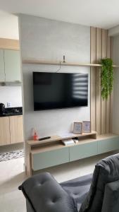 a living room with a flat screen tv on a wall at Apartamento campinas lado Puc 2 in Campinas