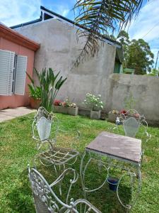 two chairs and a table in a yard at Alquiler Villa Elisa in Villa Elisa +7 photos