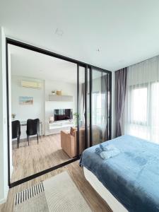 a bedroom with a large bed and a living room at The Sriracha Perch in Ban Fang Daeng +65 photos