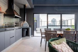 una cucina e una sala da pranzo con tavolo e sedie di Bexpspces Sky Design Alphaville a Aldeia