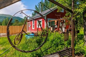 a red house with a hoop in front of it at McCarthy Lodge Resort in McCarthy