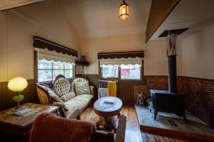 a living room with a couch and a stove at McCarthy Lodge Resort in McCarthy