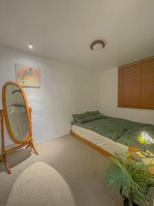 a bedroom with a bed and a mirror at 10 minutes from Hongdae pure rest in Yeonhui in Samgong +22 photos
